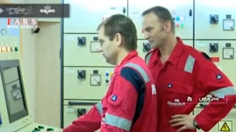 Irib Crew members monitor computers onboard the tanker