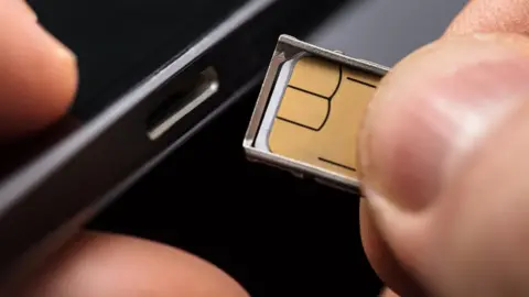 Andrey Popov/Getty Sim card