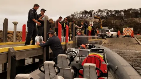 Victoria Police Police unloading water in Mallacoota from one of their smaller vessels