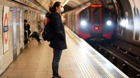 Reuters Tube covid woman in mask