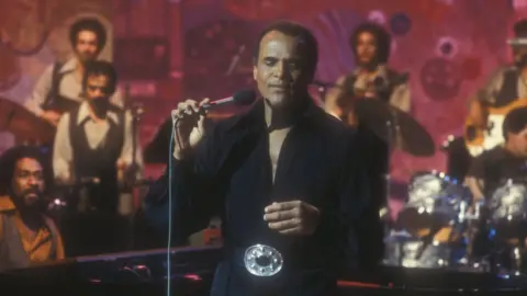 Harry Belafonte performs in 1977