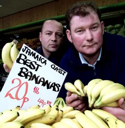 PA Media So-called 'metric martyr' Steven Thoburn (right) and colleague Neil Herron at his fruit and vegetable shop in Sunderland