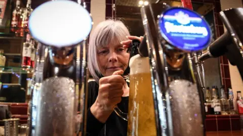 Getty Images Woman pulls pint
