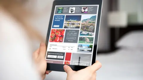 Getty Images Person looks at adverts on tablet