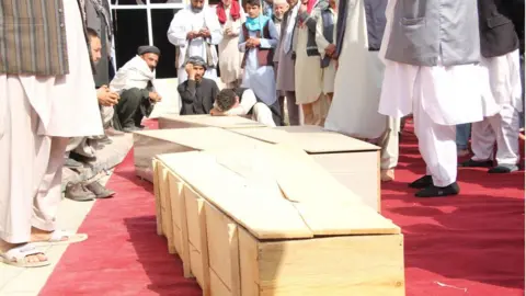 EPA Relatives attend the funeral of the victims a day after a bomb blast at a Mosque in Kunduz, Afghanistan, 09 October 2021.