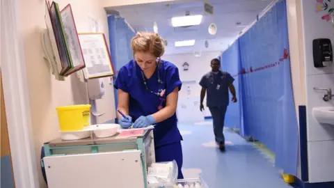 Getty Images Staff working in hospital