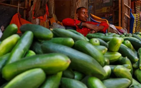 FEISAL OMAR/REUTERS A trader waits for customers at an open-air grocery market.