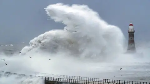 PA Media Waves break around lighthouse