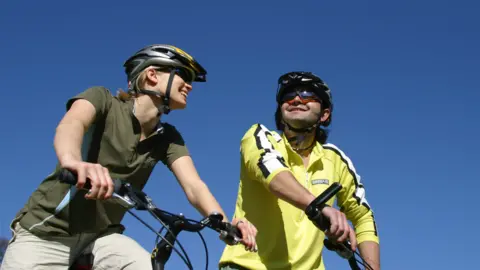 Getty Images Woman and man on bicycles