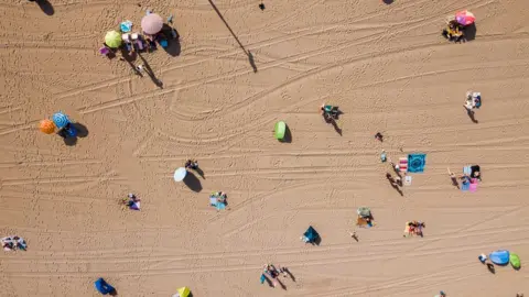 AFP An aerial photo of the first beach-goers on the beach of Scheveningen in the Netherlands