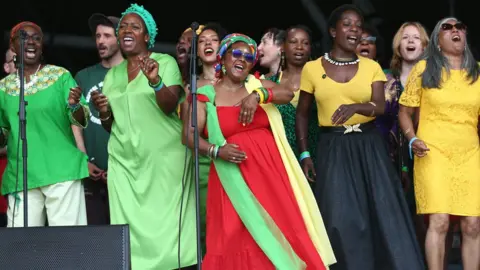 Shutterstock The Bristol Reggae Orchestra and the Windrush Choir perform on the Pyramid Stage