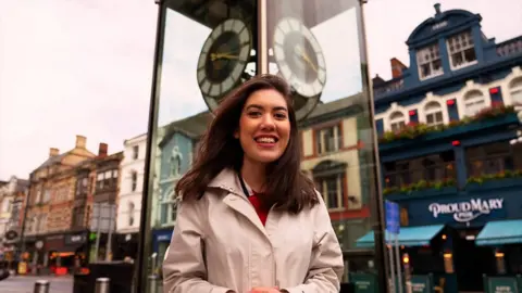 Sabrina Lee in front a clock on St Mary Street, Cardiff