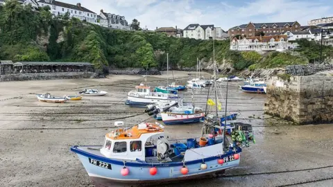 Getty Images Boat at low tide, Newquay harbour