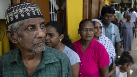 Getty Images People queuing to vote in Colombo on Saturday 15 November