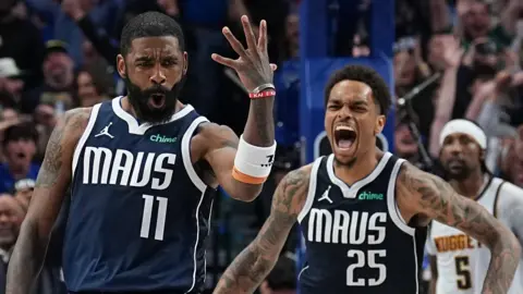 Dallas Mavericks guard Kyrie Irving celebrates hitting the game-winning shot against the Denver Nuggets