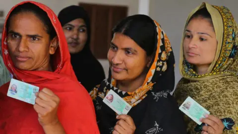 Getty Images Women stand in line to cast their votes for the Local Government Elections in front of a polling station in the town of Qasimabad, Hyderabad, Pakistan on January 15, 2023.