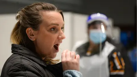 Getty Images A woman takes a coronavirus test