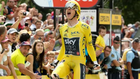 Getty Images Geraint Thomas celebrates as he crosses the finish line during stage 20 of Le Tour de France 2018