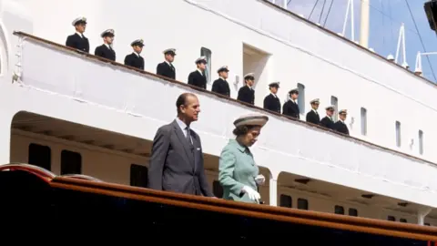 PA Media Queen Elizabeth II and the Duke of Edinburgh disembarking from the Royal Yacht Britannia in Portsmouth Dockyard during 1977 Silver Jubilee