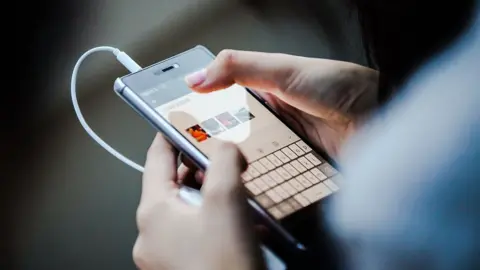 Getty Images Teen on phone