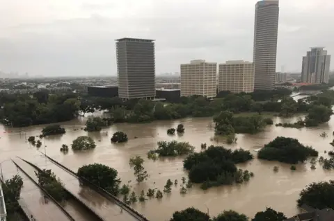 Twitter/@caroleenam/Reuters Flooded downtown Houston is seen from a high rise building along Buffalo Bayou