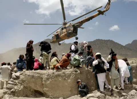 ALI KHARA A Taliban helicopter takes off after delivering aid to the site of an earthquake in Gayan, Afghanistan, June 23, 2022.