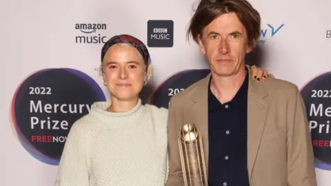 Getty Images Jessie Buckley and Bernard Butler attended the Mercury Prize shortlist announcement on Tuesday, where all nominees receive trophies