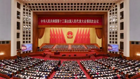 Getty Images The fourth session of the 13th National People's Congress (NPC) opens at the Great Hall of the People on March 5, 2021 in Beijing, China. (Photo by VCG/VCG via Getty Images)