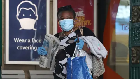 PA Media Woman at train station