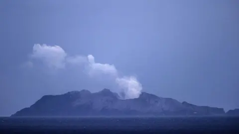 Getty Images Smoke and ash rises from a volcano on White Island early in the morning on December 9, 2019 in Whakatane, New Zealand