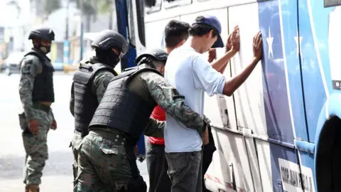 Getty Images Military officers carry out control operations in two men on October 20, 2021 in Guayaquil, Ecuador. On Monday eve, Ecuadorian president Guillermo Lasso declared a 60-day State of Emergency to confront drug trafficking and related crimes.