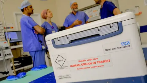 NHS Blood and Transplant box with organ for transplant reading 'handle with care: human organ in transit'