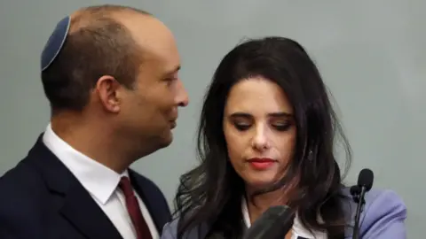 Getty Images Israeli Education Minister Naftali Bennett (L) and Justice Minister Ayelet Shaked (R) are seen together as they give a statement at the Knesset in Jerusalem on 19 November 2018.