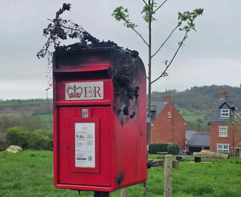 Tracey Fudge Postbox topper damaged by fire in Asker Lane, Matlock, Derbyshire