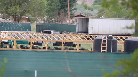 Bea Redfeather At a cannabis farm near Bea Redfeather's property, workers unload tools from a truck. The farm also has a few septic tanks and a new structure for cannabis green houses