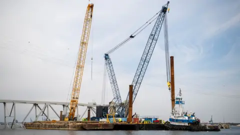 Reuters Barge cranes near the collapsed Francis Scott Key Bridge in Baltimore.