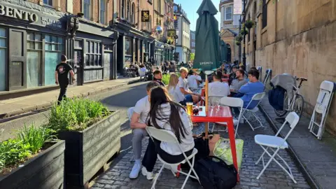 BBC Outdoor diners and drinkers at tables on St Nicholas Street in Bristol