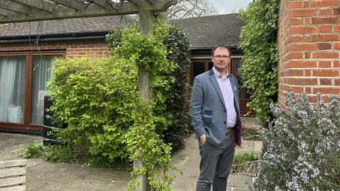 Dominik Zaum Dominik Zaum and the annexe (double doors on left) hosting two Ukrainian refugees