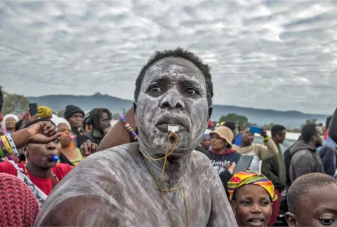Lucas Ledwaba/AFP Man with a painted face blowing on a whistle