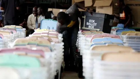 Reuters A Kenyan election tallying officer stuffs voting material into ballot boxes before they are transported to different polling stations in the Kibra Constituency at a tallying centre in Nairobi