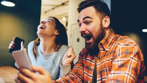 Getty Images Couple celebrating a lottery win