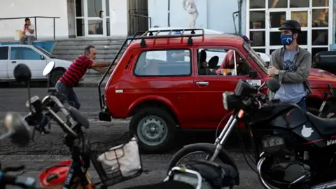 Getty Images People queue to by fuel at a gas station in Havana