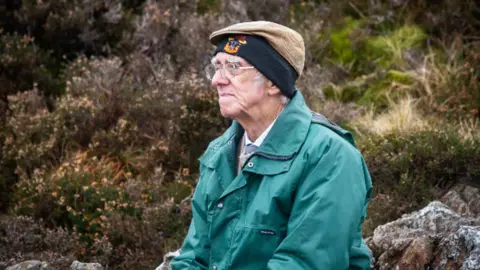 Cockermouth Mountain Rescue Team Andrew Nichol sitting by Innominate Tarn