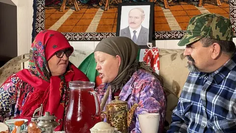 Anna Fedoronok Anna Fedoronok and co-performers sit in traditional Belarusian clothes on a sofa