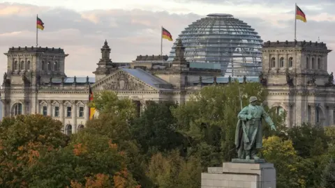 Getty Images view of the Bundestag (German parliament) and its glass dome, with the monument to the soviet soldier in the foreground on German Unity Day (Tag der Deutschen Einheit) on October 3, 2017 in Berlin, Germany