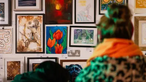 PRSC People look at art on the wall at the PAF 2023