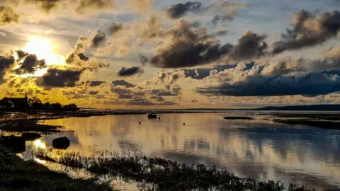 Ashley Williams The sun setting at Whiteford on the Gower