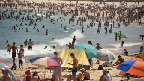 AFP/Getty Beachgoers in the waves at a beach in Sydney