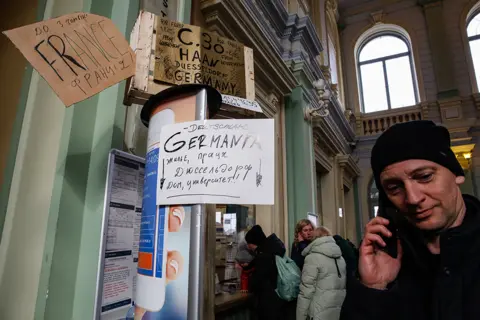 Getty Images Cardboard signs offering help in Przemysl station