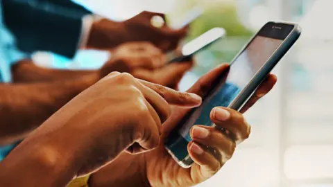 Getty Images Men using mobile phones